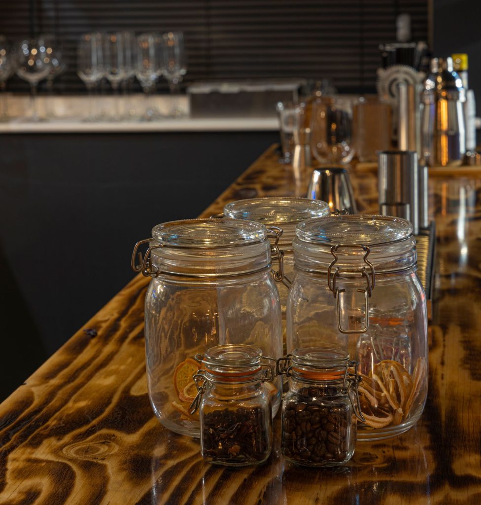 Glass storage jars on a charred timber bar top, the Log Room at the Feversham Arms, Helmsley