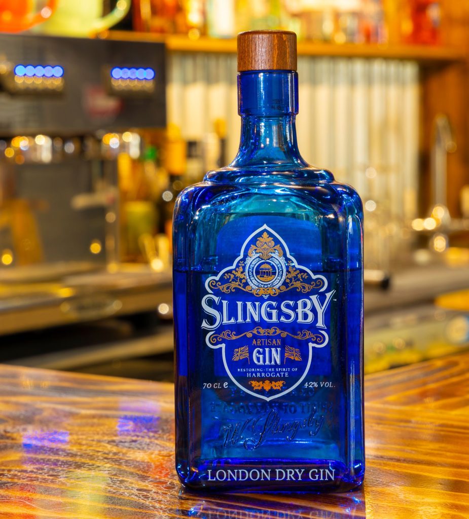 Blue gin bottle on a polished timber bar, the Log Room at the Feversham Arms, Helmsley