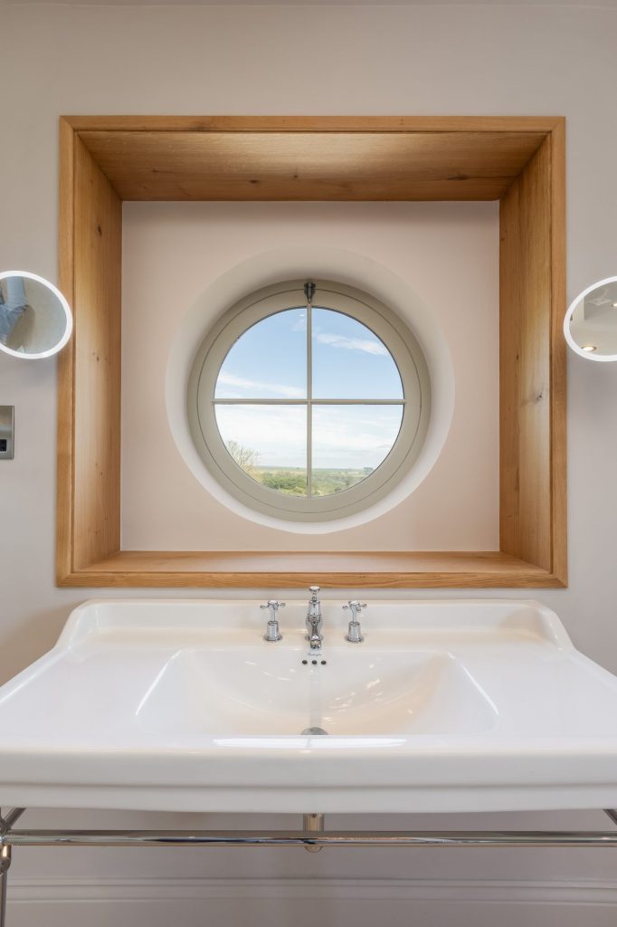 En-suite with a circular window at The Old Rectory