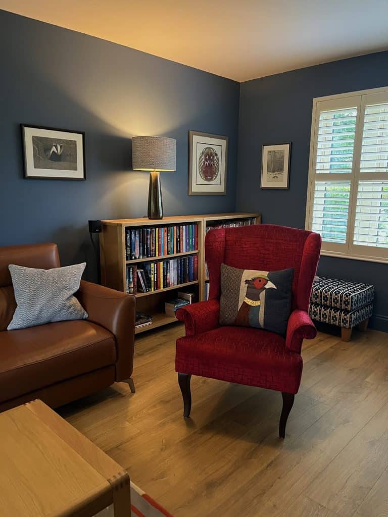 Reading corner with a red armchair and bookcase