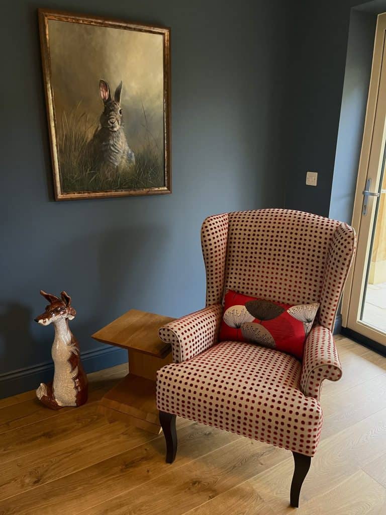 Checked wing chair in a blue sitting room